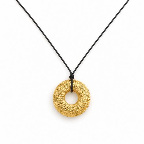 Handmade gold sea urchin pendant necklace on black cord inspired by Mediterranean marine life.