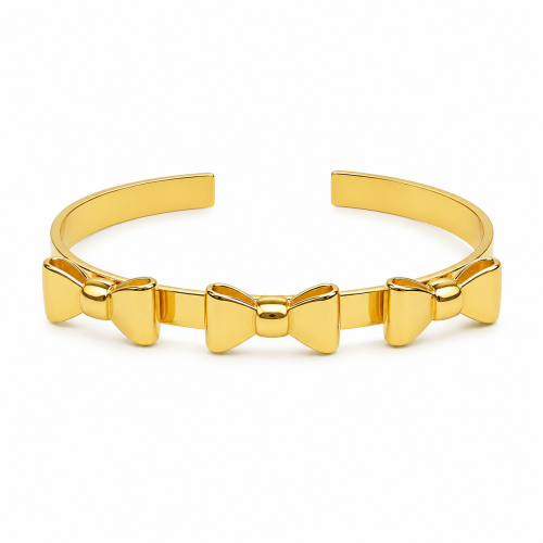 a triple bow gold cuff bracelet on white background