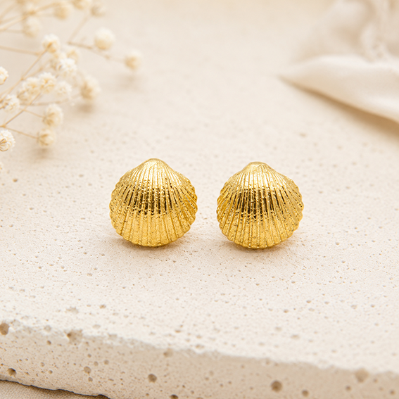 1CDD23AA-774F-4551-92F5-32FA3F454EB9 gold vermeil shell stud earrings in 925 sterling silver on beige background