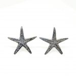 Oxidized sterling silver starfish stud earrings on white background