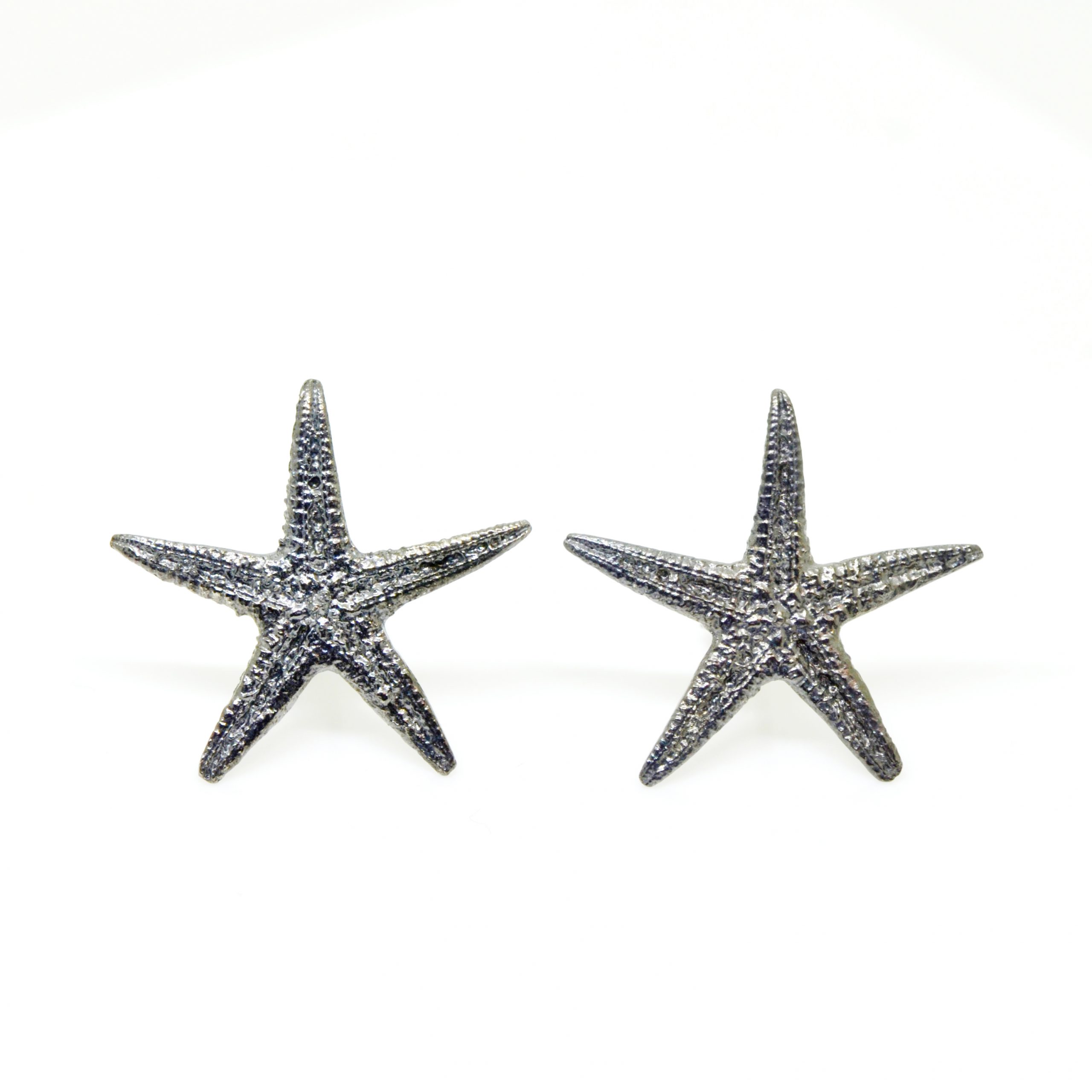 Oxidized sterling silver starfish stud earrings on white background Oxidized sterling silver starfish stud earrings on white background
