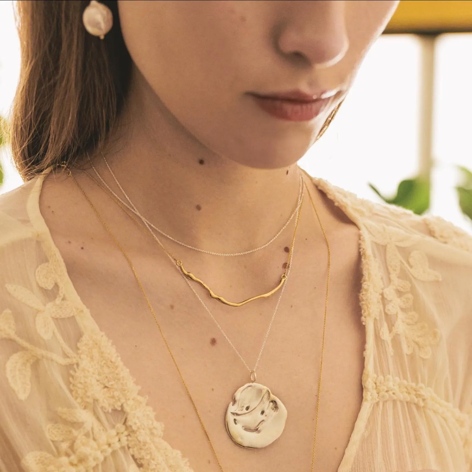 organic-bar-gold-necklace Gold organic bar necklace with a sculptural wavy pendant on a delicate chain
