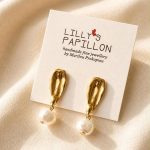 Gold pearl statement earrings with sculptural organic studs