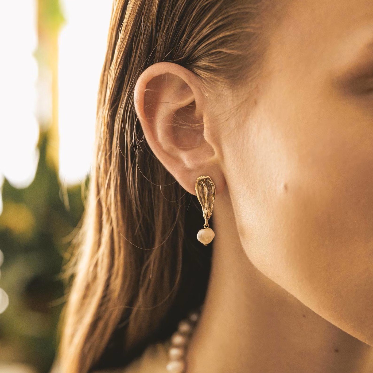 gold-pearl-drop-earrings Gold pearl statement earrings with sculptural organic studs