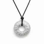 Handmade silver sea urchin pendant necklace on black cord inspired by Mediterranean marine life.